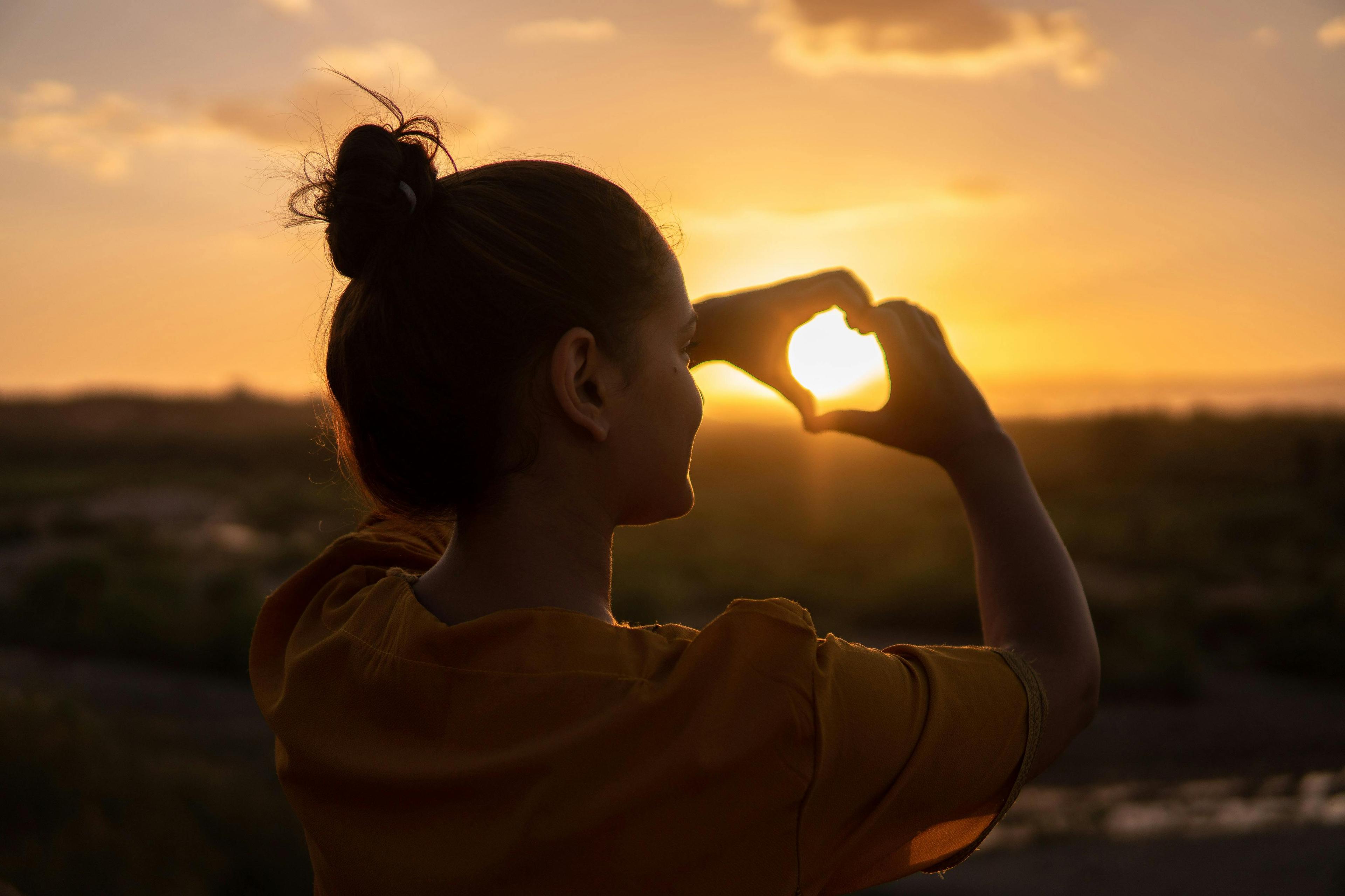 Woman smiling outdoors while looking confident